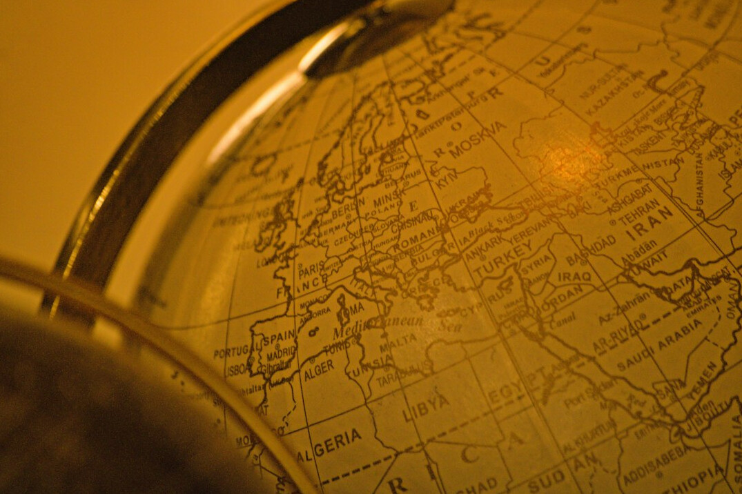 Magnifying glass resting on an old map