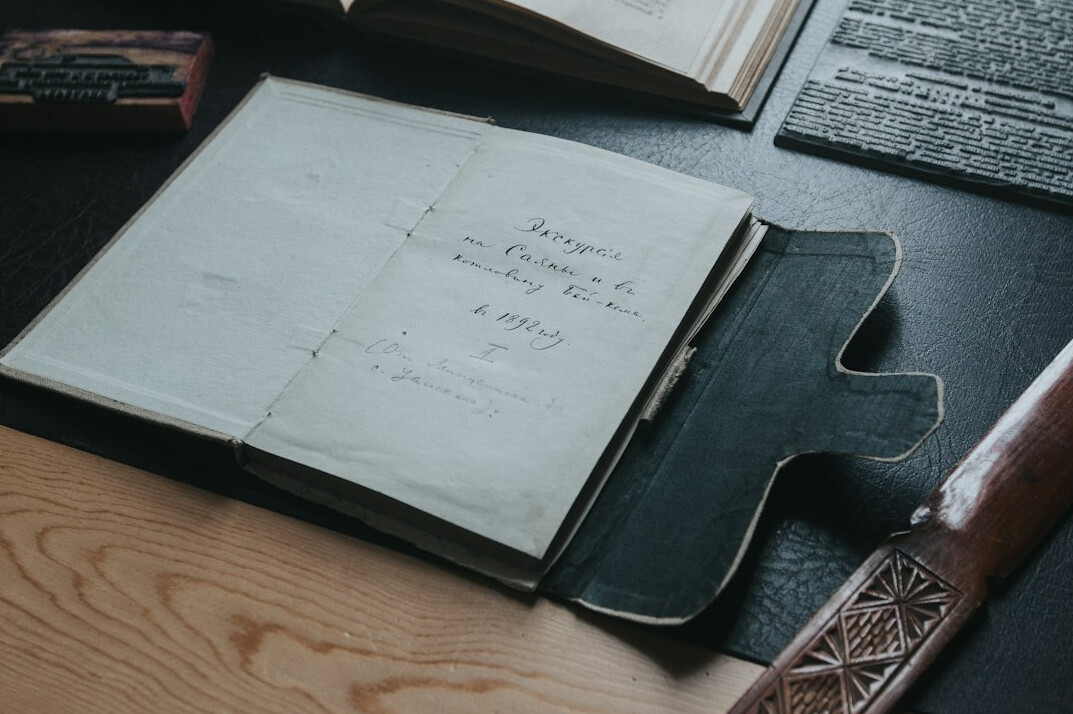Open leather notebook with handwritten notes