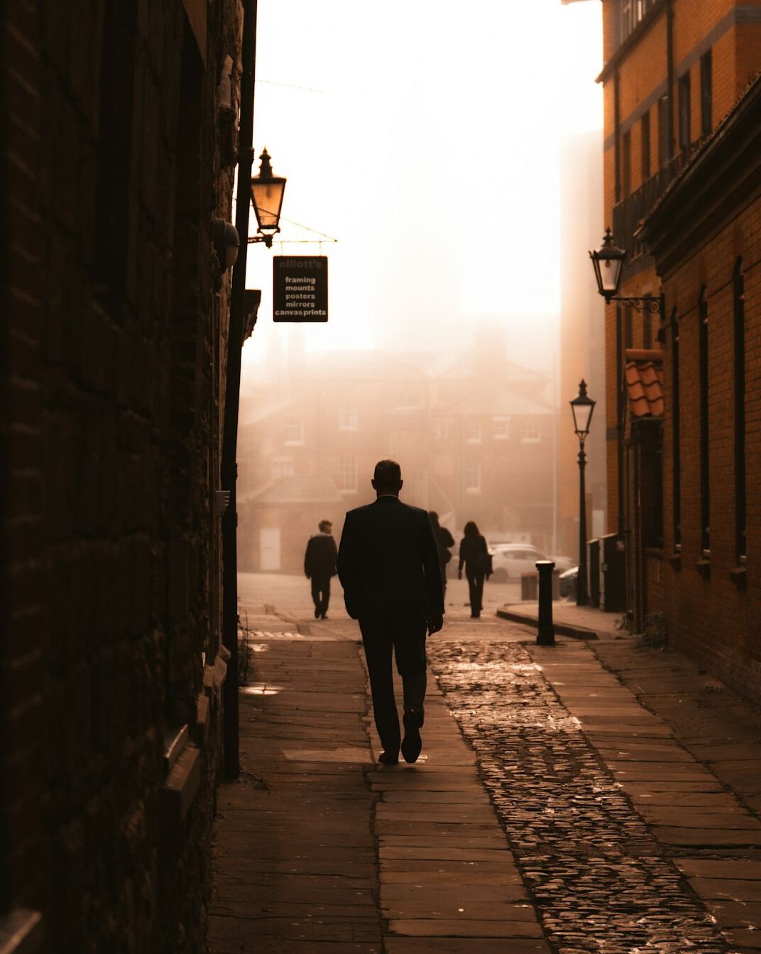Foggy old street with silhouette figure walking