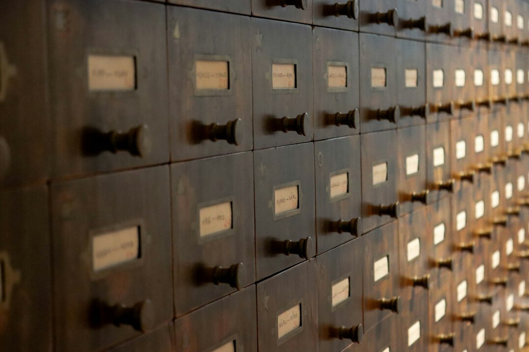 Rows of archive boxes and old documents on shelves