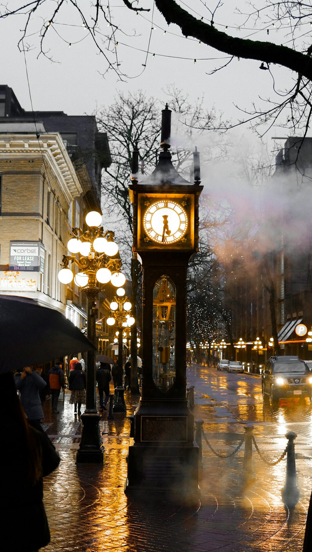 Rainy historic street with glowing lamp posts