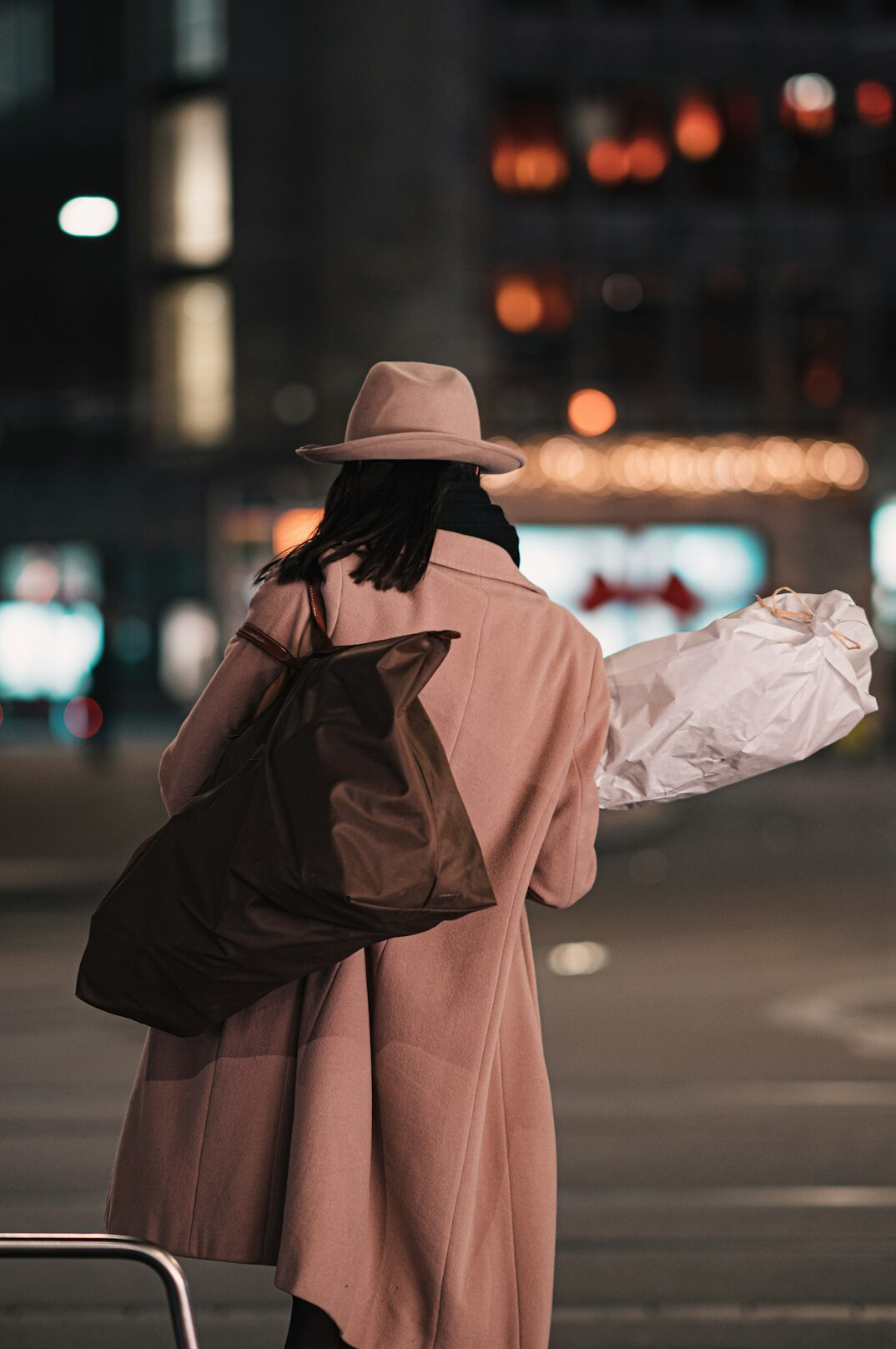 woman hiding items in bag